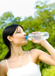 Young woman drinking water at workout, outdoors Young woman drinking water at workout, outdoors