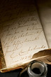 Old book with feather and inkpot Old book with feather and inkpot