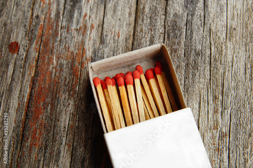 Photo: Group of matches on wooden texture Group of matches on wooden texture