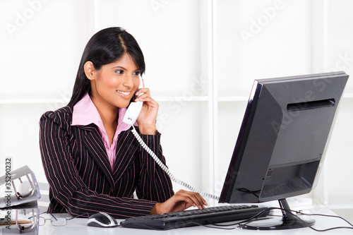 Photo: young businesswoman on the phone in office young businesswoman on the phone in office
