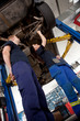 Two Mechanics Looking at Car