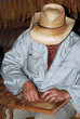 Man Rolling a Cigar.