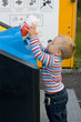 Photo: child putting waste in bin child putting waste in bin