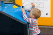 Photo: child putting waste in bin child putting waste in bin