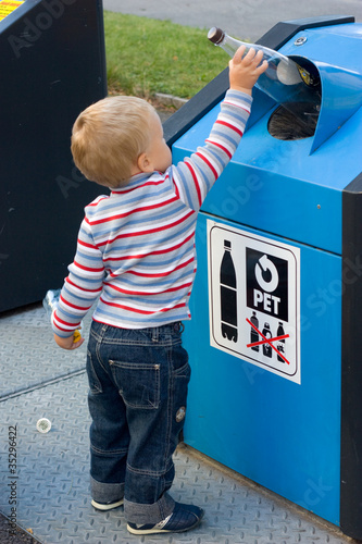 Photo: child putting waste in bin child putting waste in bin