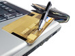 Credit card with pen on laptop ready for online purchase Credit card with pen on laptop ready for online purchase