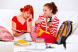 Girl showing her studying girlfriends clock