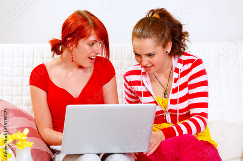 Photo: Interested girlfriends looking in laptop Interested girlfriends looking in laptop