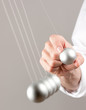 hand with newton pendulum
