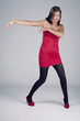 Young model in red dress posing fashion in studio