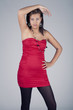 Young model in red dress posing fashion in studio