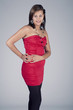 Young model in red dress posing fashion in studio