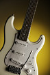 White Guitar Isolated On Yellow Spotlight