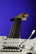 White Guitar Isolated On Blue