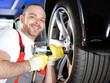 Motor mechanic is changing a tyre with new alu rim Motor mechanic is changing a tyre with new alu rim