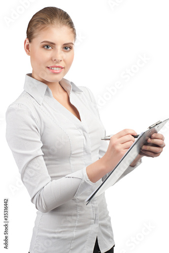 Photo: Business woman writing on clipboard Business woman writing on clipboard