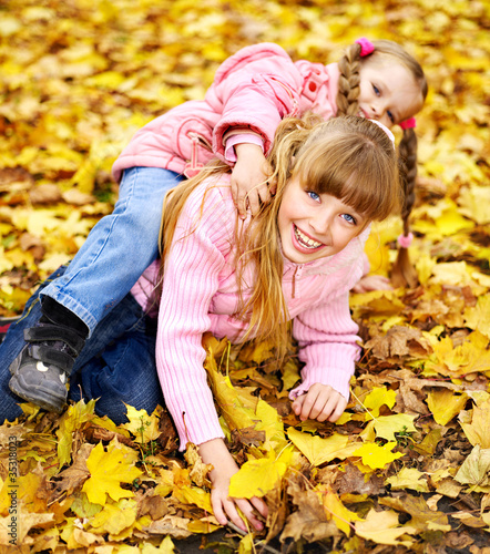 Photo: Kid in autumn orange leaves. Kid in autumn orange leaves.