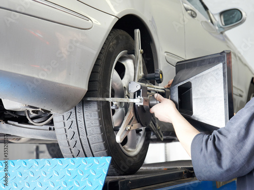 Photo: Axle alignment of a car in a garage Axle alignment of a car in a garage