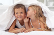 Kids sharing their secrets under the quilt