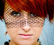 The green-eyed red-haired woman in a veil