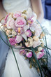 Hands of the bride with wedding bouquet