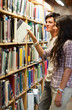 Portrait of  young students choosing a book