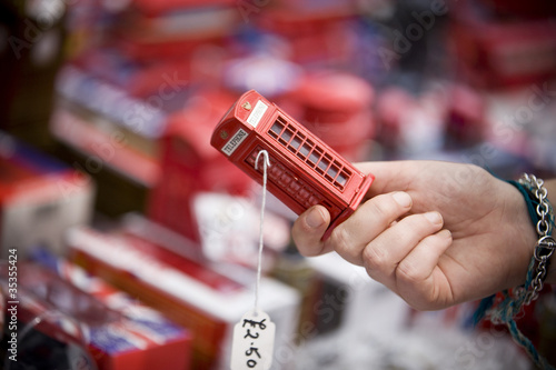 Photo: A teenage girl holding a souvenir of a red phone box A teenage girl holding a souvenir of a red phone box