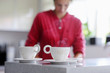 Two cups of hot tea with woman on a background