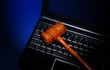 Photo: laptop computer with legal court gavel on keyboard laptop computer with legal court gavel on keyboard