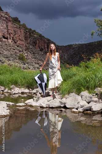 Photo: Girl enjoying a day by the river Girl enjoying a day by the river