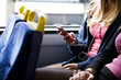 A teenage girl sitting on a bus, listening to music