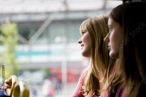 Photo: A teenage girl looking out of the window of a bus A teenage girl looking out of the window of a bus
