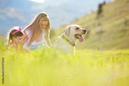 Foto: Happy family walking with dog Happy family walking with dog