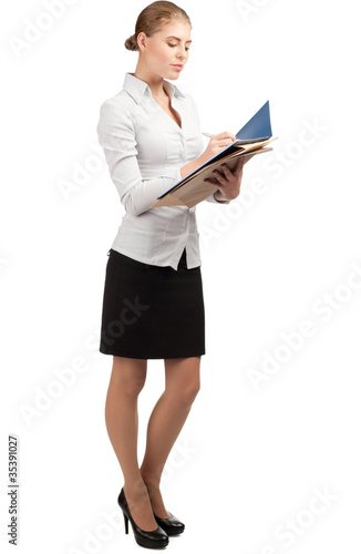 Photo: Business woman writing in documents Business woman writing in documents
