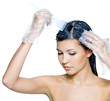 beautiful young woman dyeing hairs