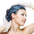 beautiful young woman dyeing hairs