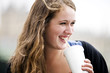 Portrait of a teenage girl drinking through a straw, smiling