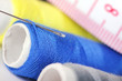 Photo: Threads with needle and measure tape Threads with needle and measure tape