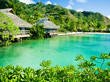 Over water bungalows and a green lagoon Over water bungalows and a green lagoon