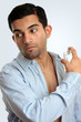 Man spraying aftershave cologne perfume