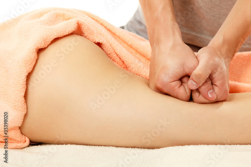 Photo: masseur makes anticellulite massage young woman isolated on whit masseur makes anticellulite massage young woman isolated on whit