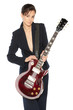 Young female in suit holding red electric guitar