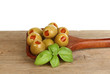 Olives and basil in wood spoon