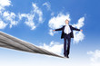 Business man balancing on the rope