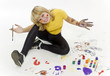Portrait of young joyful girl drawing with motley paints