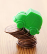Green car miniature over pennies