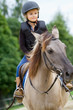 Horse riding - little girl is riding a horse
