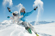 Winter, ski, snow and fun - happy skiers playing in snow Winter, ski, snow and fun - happy skiers playing in snow
