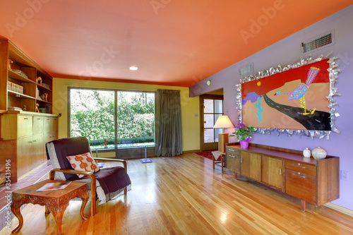 Photo: Retro bright living room with purple wall Retro bright living room with purple wall