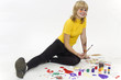 Portrait of young joyful girl drawing with motley paints